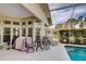 An outdoor patio space with seating, a table, grill and access to the pool at 1037 Beckley Cir, Venice, FL 34292