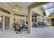 Covered patio with ceiling fan, multiple seating areas, and view of the outdoors at 1037 Beckley Cir, Venice, FL 34292