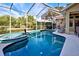 A beautiful screened in pool and spa offer a private outdoor oasis at 1037 Beckley Cir, Venice, FL 34292
