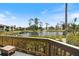 Inviting back deck overlooking the lake with a fountain and lush landscaping at 1156 Bird Bay Way # 104, Venice, FL 34285
