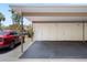 Carport attached to the home's exterior featuring storage closets and vehicle parking at 1156 Bird Bay Way # 104, Venice, FL 34285