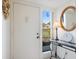 Light and bright condo entryway featuring a table with lamp and a view through sidelight window at 1156 Bird Bay Way # 104, Venice, FL 34285