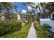 Beautifully landscaped walkway leading to an elevator and the condo building at 1156 Bird Bay Way # 104, Venice, FL 34285