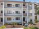 Condo building with private balconies, featuring landscaped grounds at 1156 Bird Bay Way # 104, Venice, FL 34285