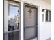 Condo front door with security screen, address number, and sidelight window at 1156 Bird Bay Way # 104, Venice, FL 34285