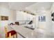 Bright kitchen features white cabinets, stone countertops, and breakfast bar seating at 1156 Bird Bay Way # 104, Venice, FL 34285