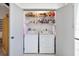 Laundry room featuring a washer and dryer, storage space and shelving at 1156 Bird Bay Way # 104, Venice, FL 34285