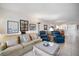 Comfortable living room with neutral tones and a view of the dining area at 1156 Bird Bay Way # 104, Venice, FL 34285