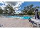 Community pool with lounge chairs and tables for relaxation and enjoyment at 1156 Bird Bay Way # 104, Venice, FL 34285