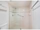 Modern shower featuring glass doors, a tiled wall and stainless steel hardware at 1156 Bird Bay Way # 104, Venice, FL 34285