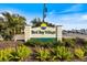Community sign surrounded by lush landscaping, and easy access to roadways at 1156 Bird Bay Way # 104, Venice, FL 34285