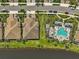 Aerial view of beautiful homes, green lawns, pool, and waterway at 11648 Okaloosa Dr, Venice, FL 34293
