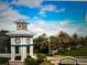 View of the Grand Palm entrance sign and gatehouse on a sunny day with landscaping at 11648 Okaloosa Dr, Venice, FL 34293