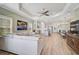 Open floor plan showcasing living room, kitchen, and dining area with wood-look flooring and neutral decor at 11648 Okaloosa Dr, Venice, FL 34293