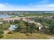 Aerial view of the condo community featuring a pool, lush greenery, and nearby waterways at 1190 Bird Bay Way # 309, Venice, FL 34285