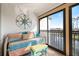 Cozy balcony with daybed, compass decor, and sliding doors with a view of the water at 1190 Bird Bay Way # 309, Venice, FL 34285