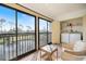 Enclosed balcony offering water views and featuring laundry facilities at 1190 Bird Bay Way # 309, Venice, FL 34285