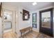 Inviting entryway with bench, mirror, and a glimpse into the stylish bathroom at 1190 Bird Bay Way # 309, Venice, FL 34285