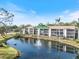 Waterfront condo has screened in patios and a fountain in the pond at 1190 Bird Bay Way # 309, Venice, FL 34285