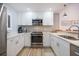 Beautiful kitchen with stainless appliances, white cabinets and stone backsplash at 1190 Bird Bay Way # 309, Venice, FL 34285