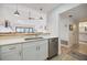 Lovely white kitchen with breakfast bar pass through overlooking the living spaces at 1190 Bird Bay Way # 309, Venice, FL 34285