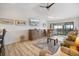 Bright living room with vaulted ceilings, wood floors, and screened lanai access at 1190 Bird Bay Way # 309, Venice, FL 34285