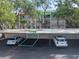 Assigned parking spot at condo community in a carport with white cars parked at 1190 Bird Bay Way # 309, Venice, FL 34285
