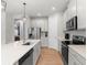 Stylish kitchen with stainless steel appliances, a center island, and bright white cabinets at 12450 Somatic Ct, Venice, FL 34293
