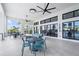 Open-air patio with ceiling fans, comfortable seating, and views of the waterfront and pool at 12450 Somatic Ct, Venice, FL 34293