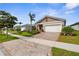 A well-maintained street view showcases the homes, sidewalks, lush lawns, and landscaping in the community at 12450 Somatic Ct, Venice, FL 34293