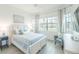 Bright bedroom with a large window and a cozy sitting area at 12548 Wellen Golf St, Venice, FL 34293