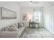 Cozy bedroom features a comfortable sofa, a work desk, and ample closet space at 12548 Wellen Golf St, Venice, FL 34293