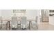 Bright dining room with wood table, woven chairs, and stainless steel refrigerator at 12548 Wellen Golf St, Venice, FL 34293