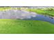 Expansive aerial view of a golf course with a serene lake, providing a beautiful and challenging landscape for golfers at 12548 Wellen Golf St, Venice, FL 34293