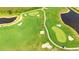 Expansive aerial view of a golf course showcasing its lush green fairways, strategic sand traps, and winding cart paths, ideal for golfers at 12548 Wellen Golf St, Venice, FL 34293