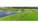Picturesque golf course driving range with a serene lake backdrop, perfect for practicing and improving your game at 12548 Wellen Golf St, Venice, FL 34293