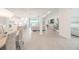 Bright open-concept living area features a modern kitchen and elegant dining space at 12548 Wellen Golf St, Venice, FL 34293