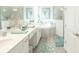 Elegant bathroom with dual sinks, a soaking tub, and a separate shower, designed for relaxation at 12548 Wellen Golf St, Venice, FL 34293