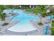 Expansive community pool with shallow areas, lap lanes, lounge chairs, and umbrellas offering a luxurious resort-style experience at 12548 Wellen Golf St, Venice, FL 34293
