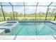 Relaxing screened-in pool area with an attached spa and beautiful backyard views at 12548 Wellen Golf St, Venice, FL 34293