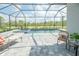 Inviting screened-in pool patio featuring comfortable lounge chairs and scenic views of lush landscaping at 12548 Wellen Golf St, Venice, FL 34293