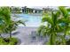 Inviting community pool area with comfortable lounge chairs, palm trees, and a modern clubhouse in the background, perfect for relaxation at 12548 Wellen Golf St, Venice, FL 34293