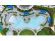Aerial view of a resort-style pool with ample lounge seating, cabanas, and beautiful landscaping for a luxurious experience at 12548 Wellen Golf St, Venice, FL 34293