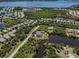 Expansive aerial view of a coastal community with waterfront homes and lush greenery at 13314 Prentice Ave, Port Charlotte, FL 33953
