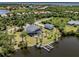 Gorgeous backyard with private pool, dock, and waterfront access, surrounded by palm trees at 13314 Prentice Ave, Port Charlotte, FL 33953