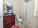 Cozy bathroom features a wood vanity with black countertop and shower with curtain at 13314 Prentice Ave, Port Charlotte, FL 33953