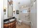 Bathroom featuring dark wood vanity with granite countertop, and tub with shower at 13314 Prentice Ave, Port Charlotte, FL 33953