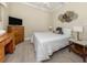 Bedroom with a light color scheme, light wood laminate flooring, and traditional furnishings at 13314 Prentice Ave, Port Charlotte, FL 33953