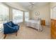 Bright bedroom featuring a sitting area in front of bay windows, neutral decor, and carpeted floor at 13314 Prentice Ave, Port Charlotte, FL 33953