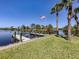 Private dock on the water with American flag and lift, perfect for boating and fishing at 13314 Prentice Ave, Port Charlotte, FL 33953